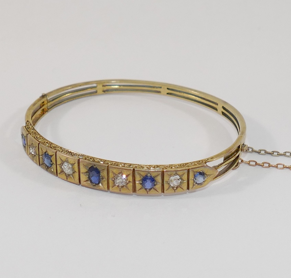 A late19th/early 20th century possibly French sapphire and diamond set hinged bangle, the four old-