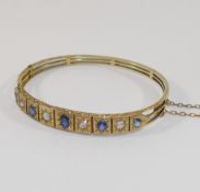 A late19th/early 20th century possibly French sapphire and diamond set hinged bangle, the four old-