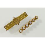 A Victorian yellow metal bar brooch stamped '15CT', 4.5cm long, 6g, and another yellow metal bar