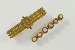 A Victorian yellow metal bar brooch stamped '15CT', 4.5cm long, 6g, and another yellow metal bar