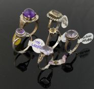 A collection of 12 amethyst and citrine set rings, including some set with marcasite, most