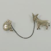 A Mexican Maricela two-part brooch of a donkey and his sleeping owner, joined by a chain, stamped '