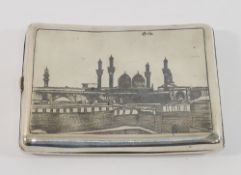 An Iraqi silver and niello cigarette case decorated with a camel and traders to one side and a