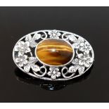 Four items of tiger's eye jewellery comprised of a large single stone ring, a circular openwork
