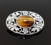 Four items of tiger's eye jewellery comprised of a large single stone ring, a circular openwork