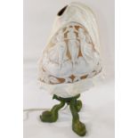 A large Queen helmet conch shell cameo carved with a classical scene of the three graces, mounted to