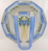 An Art Nouveau wash jug and bowl, with floral transfer printed decoration and panelled sides, the