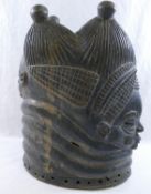 An African Mende carved helmet mask from Sierra Leone, carved with two faces (front and back),