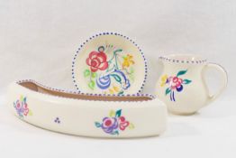 A collection of twelve items of mainly 1950's and later Poole Pottery, hand painted with flowers,