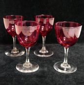 A set of four Victorian wine glasses, with cranberry glass panel cut bowls, 12cm highCONDITION
