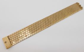 A 9 carat gold flat brick link bracelet with textured bark finish, London 1972, 2.2cm wide, 60g