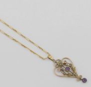 An Edwardian amethyst and seed pearl set openwork pendant, stamped '9CT', 4.2cm long, 1.7g, and a