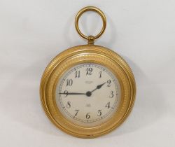 A gilt metal cased circular Jaeger wall clock in the form of a pocket watch, with battery powered