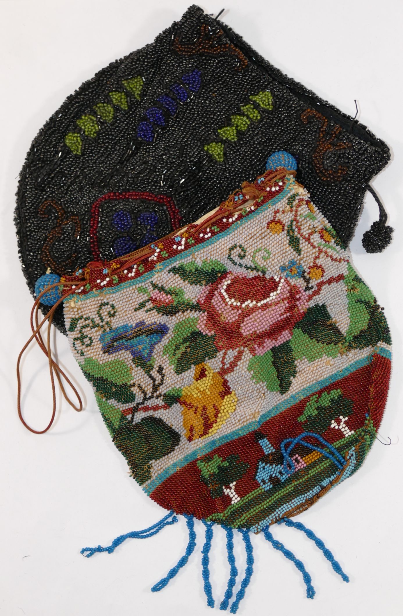 Two Victorian beaded drawer string bags, one with chamois lining, decorated with flowers, 14cm long,