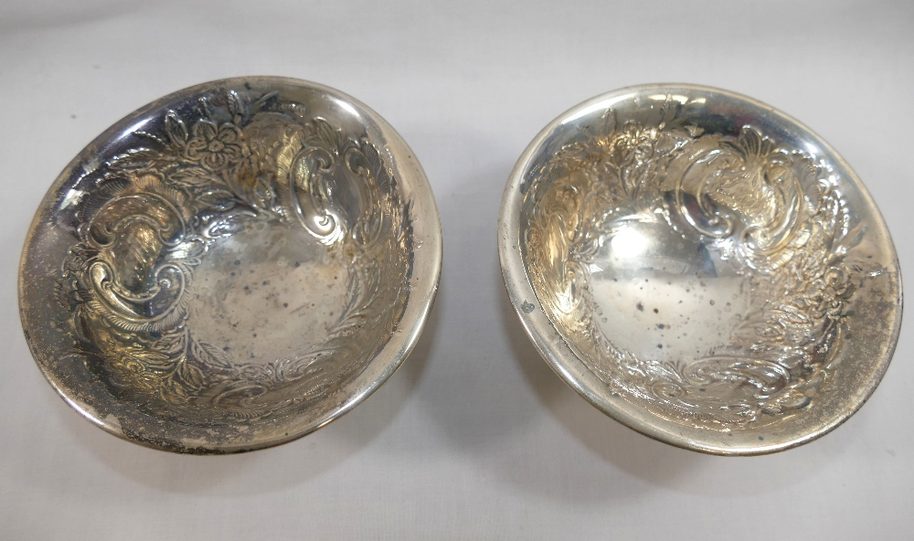 A pair of Edwardian footed silver bowls, Birmingham 1902, with embossed floral and scroll