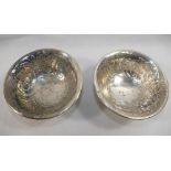 A pair of Edwardian footed silver bowls, Birmingham 1902, with embossed floral and scroll