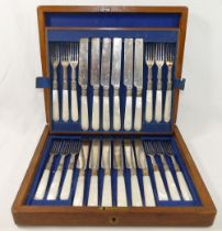 A set of 12 mother of pearl handled silver plated fruit knives and forks, housed in a mahogany