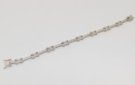 A ribbon twist and bar link line bracelet, 6mm wide, with box clasp, set with diamond simulants,