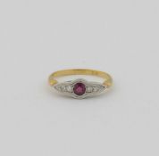 An early 20th century ruby and diamond five stone ring, the round mixed cut ruby flanked on either