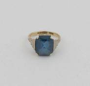 A 9 carat gold 1950's synthetic blue spinel single stone ring, the emerald cut stone set in white