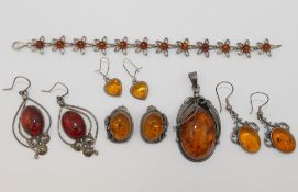 A collection of modern amber jewellery, in a variety of settings stamped '925', comprised of a large