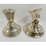 Two squat silver candlesticks, with loaded bases, both at fault CONDITION REPORTS & PAYMENT