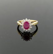 A ruby and diamond oval cluster ring, the oval mixed cut treated ruby 0.92 carats, within illusion