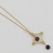 An Edwardian amethyst and seed pearl openwork pendant, with amethyst drop, stamped ‘15ct’, 4.6cm