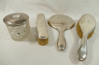 A three-piece silver backed brush and hand mirror dressing table set, Birmingham 1916, and a