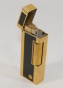 A Dunhill gold plated and black enamel Rollalite pocket lighter, numbered 113351 CONDITION REPORTS &