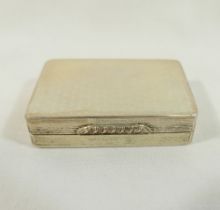 A rectangular silver pill box with gilt interior, engine turned decoration and ornate cast thumb