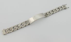 A large silver identity bracelet, the links with bark finish, London 1982, 1.4cm wide, 3.14ozt, 97.