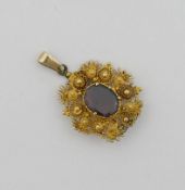 A 19th century garnet set gold filigree oval pendant, the garnet in foiled closed back setting,