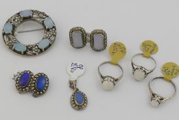 A selection of opal set jewellery, comprised of a circular brooch stamped 'SILVER', set with five