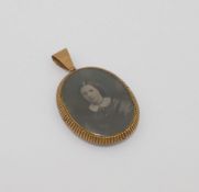 A Victorian pinchbeck double sided locket, housing an early photograph of a young woman, the reverse