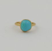 A turquoise single stone ring, the irregular shaped cabochon stone approximately 1cm diameter, in