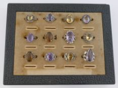 A collection of 12 amethyst and citrine set rings, including some set with marcasite, most