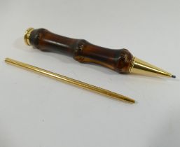 A Jacques Cartier 18 carat gold mounted bamboo cased propelling pencil, London 1961, 11.5cm long,