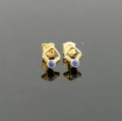 A pair of yellow metal sapphire set stud earrings, the butterfly backs stamped '750', and an