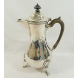 A George V silver hot water jug, Sheffield 1910, with ebonised handle and knop, of baluster form,