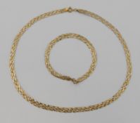 A 9 carat gold tri-colour plaited necklace, 41.5cm long, 6mm wide, and matching bracelet, combined