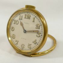 A vintage Cartier circular travel clock with 8-day movement, gold plated brass case, numbered 12186,