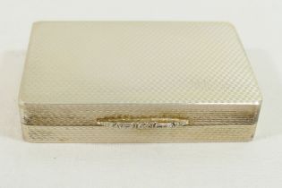A rectangular silver snuff box with gilt interior, engine turned decoration and ornate cast thumb