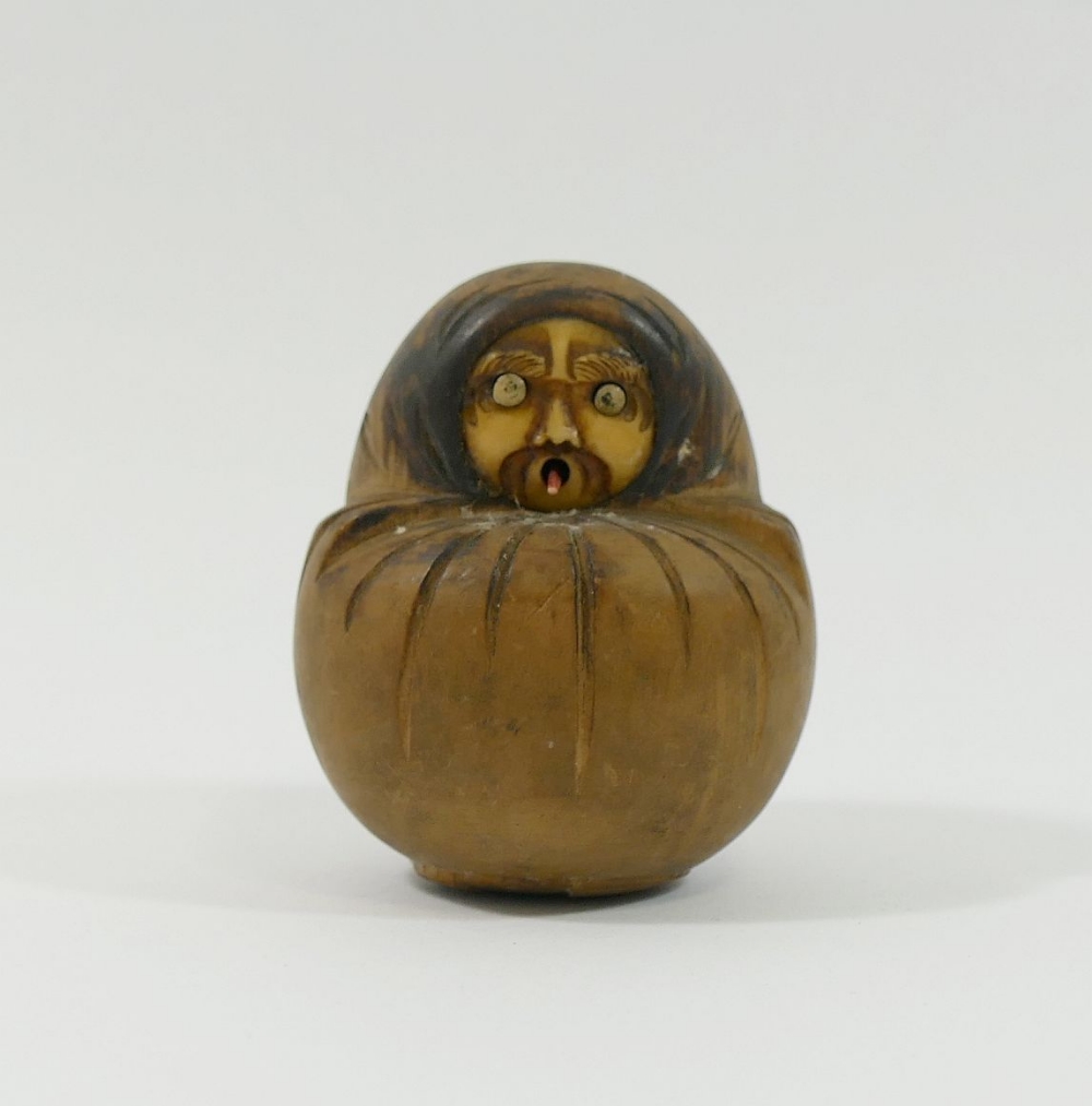 An early 20th century Japanese carved wooden Kobe Daruma doll, with moving projecting eyes and