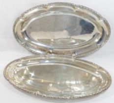 A pair of French silver serving dishes, cast with ornate rim, bearing import marks for London