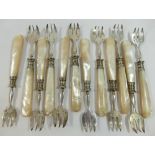 A set of twelve 19th century French silver oyster forks with mother of pearl handles, each bearing a