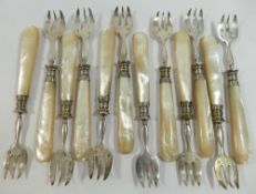 A set of twelve 19th century French silver oyster forks with mother of pearl handles, each bearing a