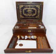A Victorian mahogany Winsor and Newton paint box, the interior of the lid inset with ornately gilt