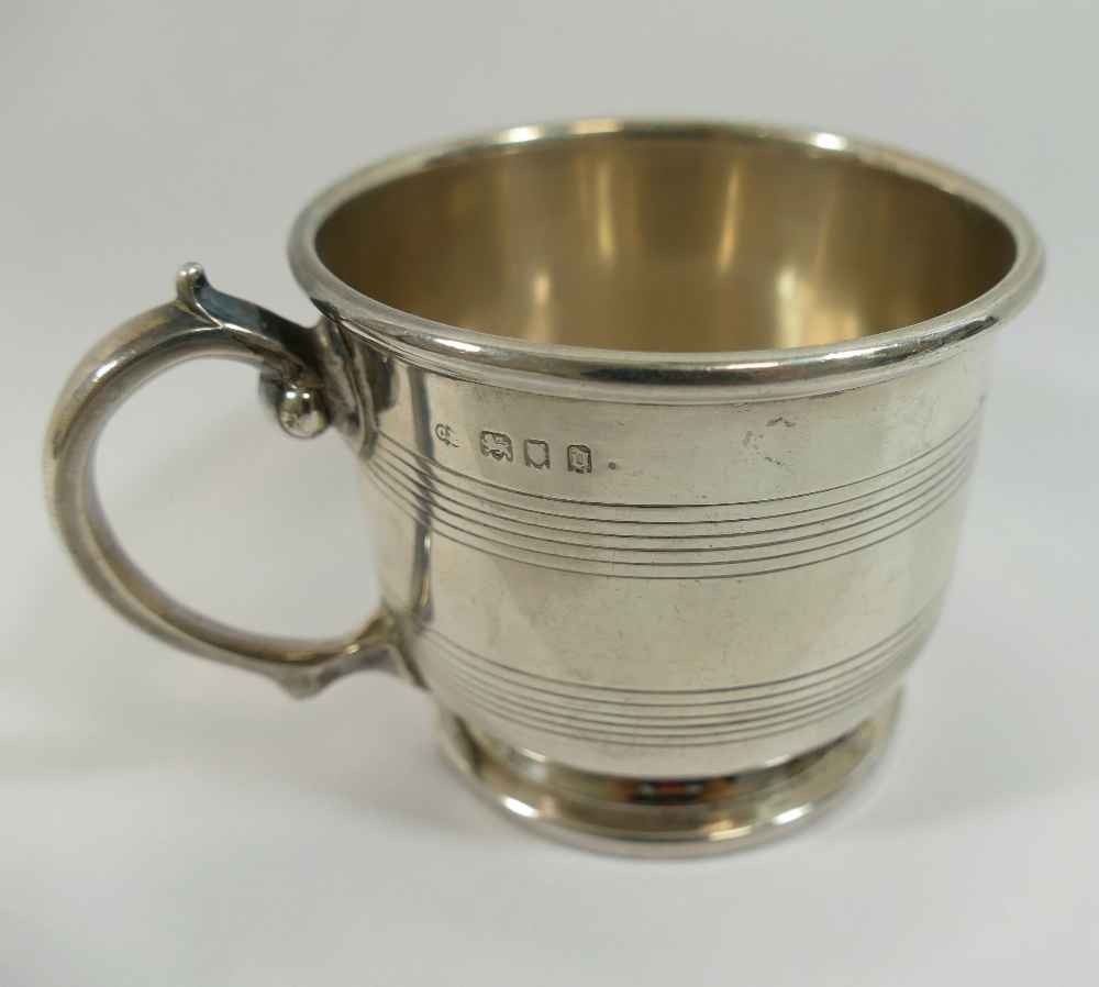 A George V silver cup, London 1919, the straight sides with reeded banded decoration, raised on