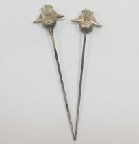 A pair of hollow silver topped hat pins, Birmingham 1911, maker's mark 'P&T', the silver top 2.3cm